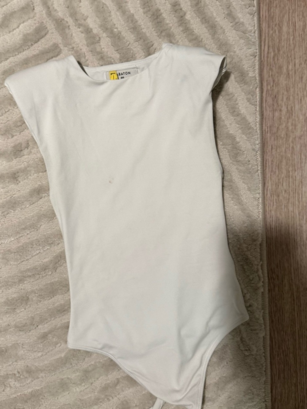 Babaton White Sleeveless Shoulder Pad One-Piece Bodysuit